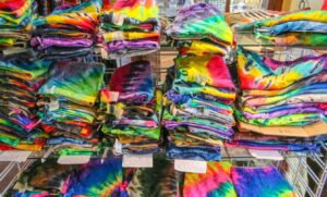 Tie dye shirts on display in a store.