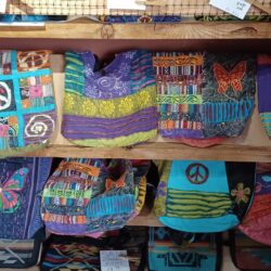 A display of colorful bags and other items in a store.