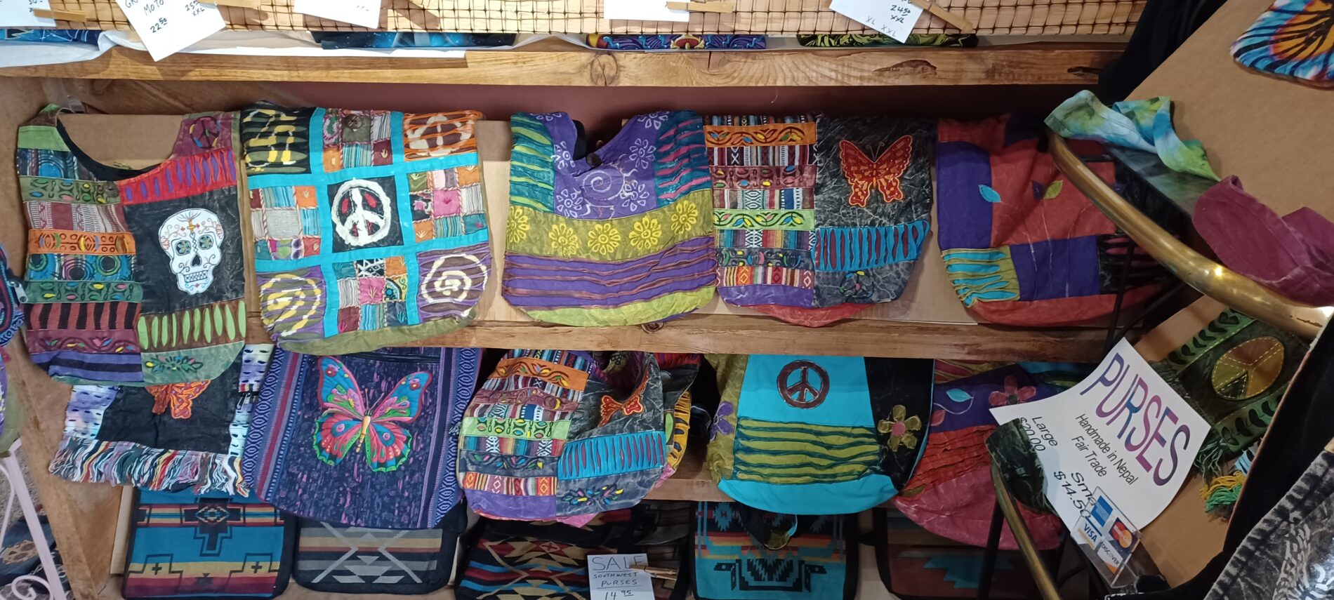 A display of colorful bags and other items in a store.